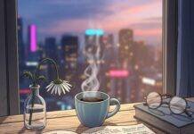 What to Expect in Your First Life Coaching Session? Cozy desk, coffee, notebook, city view.