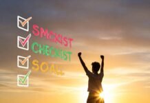 SMART Goals 101: How to Set Goals You’ll Actually Achieve Triumphant figure checks off SMART goal at sunrise.