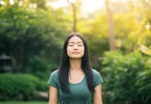 7 Breathing Techniques to Relieve Stress in Minutes Person meditating outdoors in soft sunlight, lush greenery.