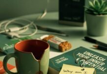 Is Life Coaching Worth It? A Deep Dive into the Benefits Cluttered Brooklyn desk with coffee, book, and sticky note.