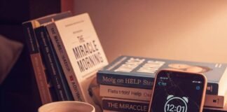 How to Build a Morning Routine You’ll Actually Stick to A close-up of a messy nightstand with an alarm clock